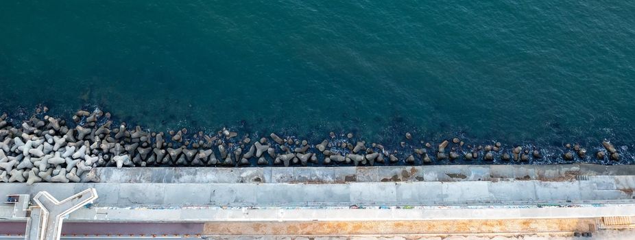 Aerial top view from drone to the seacoast and  concrete pier