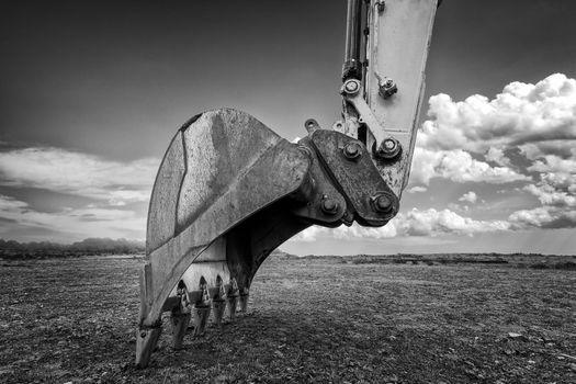 Industrial background. Digger bucket close-up. Construction excavator bucket.