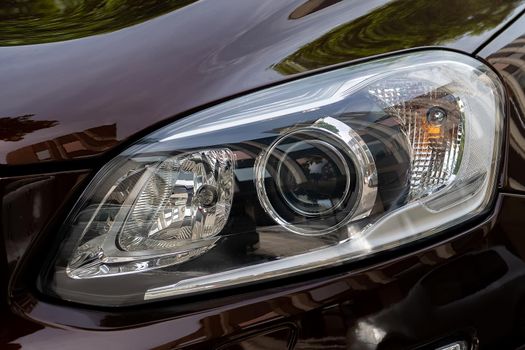 Headlight. LED headlamp of a modern car. Frontal lighting of highway vehicles 