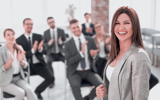 young business woman on the background of applauding business team.photo with copy space