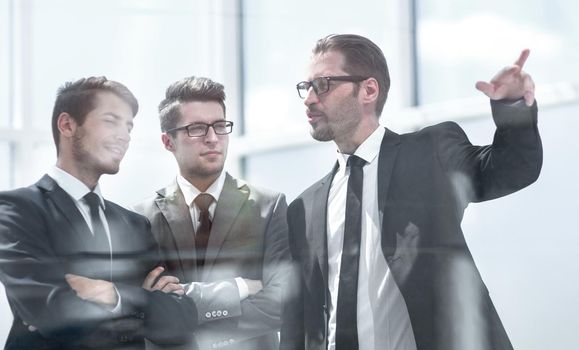 business partners standing near the office window.photo with copy space