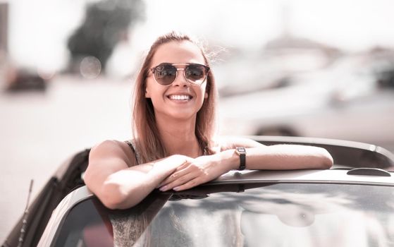 modern girl enjoying a trip in a convertible.urban lifestyle
