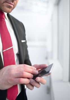 close up.businessman reading text message on smartphone.people and technology