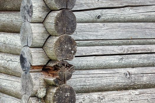 Close up on a old timber beam. Beautiful wooden pattern and with some lichens. On an old farmhouse on the countryside