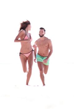 Couple Running Through Waves On Beach Holiday