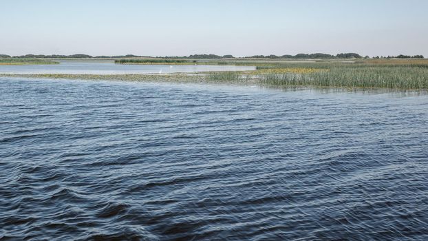 Shallow water and white winches in the distance