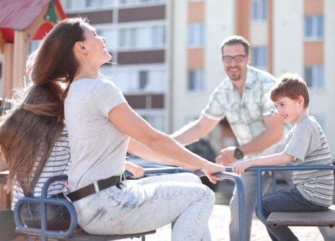 happy family on the Playground.family holiday concept