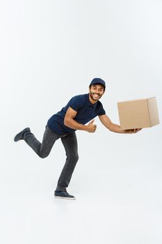 Delivery Concept - Handsome African American delivery man rush running for delivering a package for customer. Isolated on Grey studio Background. Copy Space