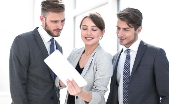 modern business team using tablet computer to work with financial data. people and technology