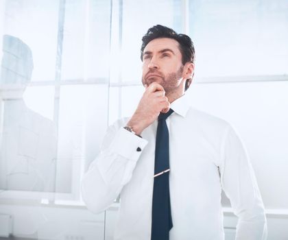 dreaming businessman standing in the office.business concept