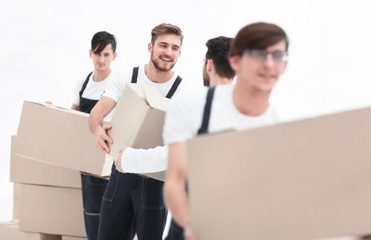 Photo workers pass each other boxes when moving flats