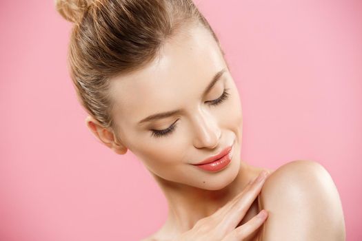 Beauty Concept - Close up Portrait of attractive caucasian girl with beauty natural skin isolated on pink background with copy space