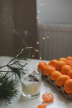 Christmas background with fir tree branches and tangerines. Merry Christmas and Happy New Year Greeting Card. Copy space. Top view. High quality photo