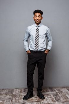 Business Concept - Full length portrait of confident african american businessman in the office