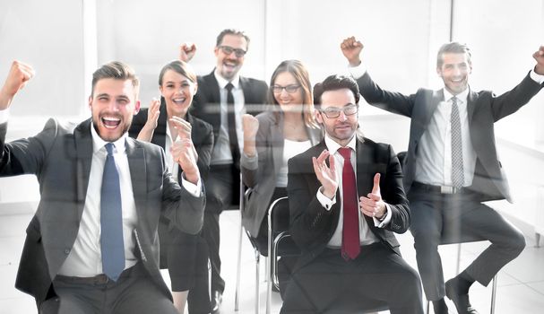 happy business team sitting in conference room. Business and entrepreneurship