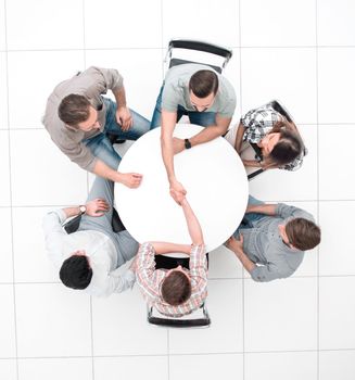 top view. handshake colleagues at the round table.business meeting