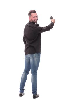 in full growth. young man dialing a number on his smartphone. isolated on white background