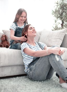 little girl playing with her mother in the hairdresser .a day of beauty