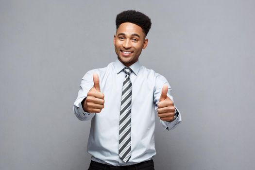 Business Concept - Successful African American Businessman showing thump up in front of him