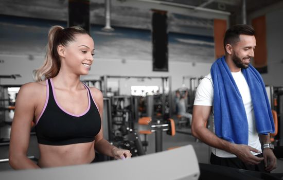 attractive sports couple talking in the gym . healthy lifestyle