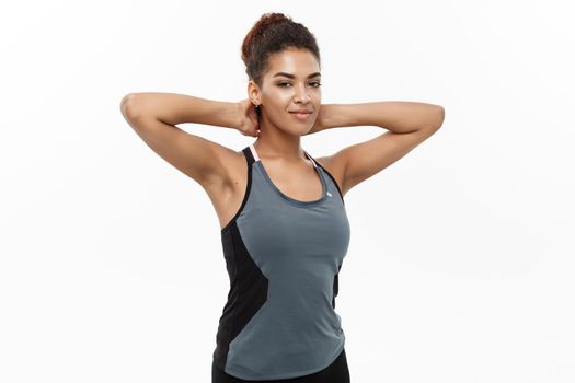 Healthy and Fitness concept - portrait of African American girl posing with fitness clothes over white studio.