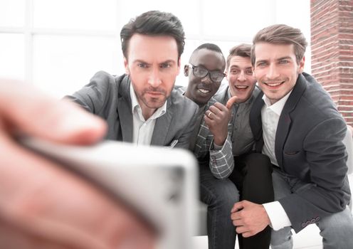 happy business team takes selfies .photo on memory
