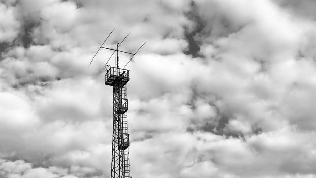  antenna for communications and television and radio with cloudy skies in the background, black and white images