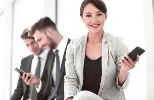 young business woman sitting in office lobby during work break.people and technology