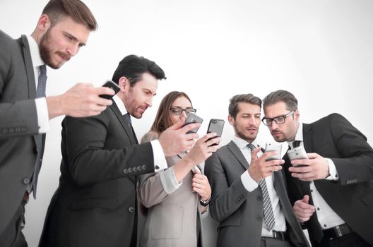 Group of young Businessman and Businesswoman looking at their smartphones and discussing for their project. Business and internet concept.