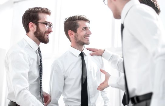 smiling employees shaking hands.the concept of cooperation