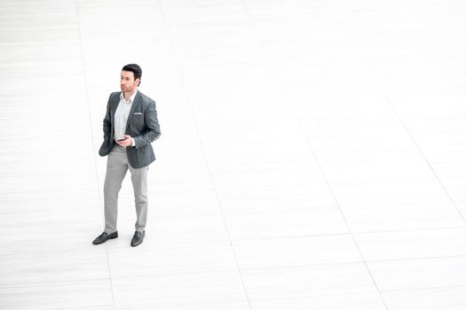 view from afar.businessman looks at the screen of the smartphone.photo with copy space