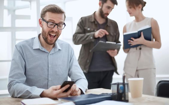 business man reads messages on his smartphone during working hours. people and technology