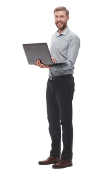 in full growth. smiling young businessman with laptop. isolated on white background