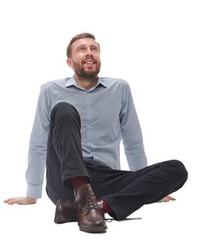 in full growth.tired businessman sitting on the floor . isolated on white background