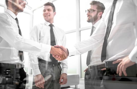 business colleagues shaking hands in the office.business concept