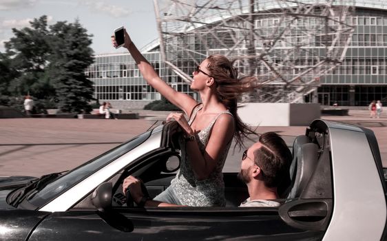 young couple taking selfie while traveling around the city .people and technology