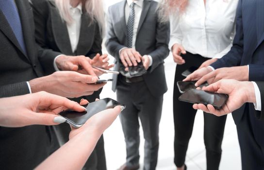 close-up of smartphones in the hands of business youth.people and technology