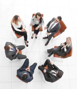 view from the top.successful business team sitting in a circle and looking at the camera.