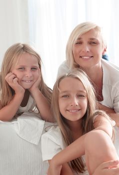 portrait of a mother with two small daughters . isolated on white background