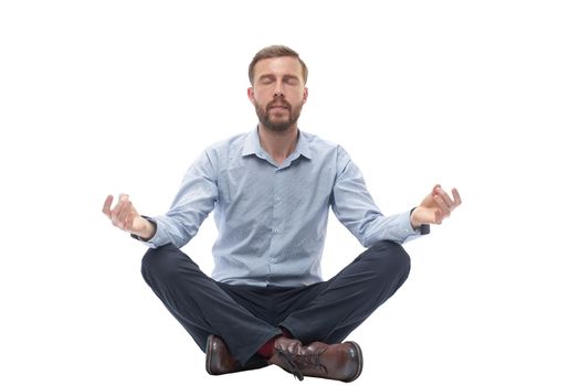 young businessman meditates sitting on the floor . isolated on white background