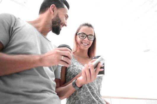 young couple reading SMS on their smartphone.the concept of lifestyle