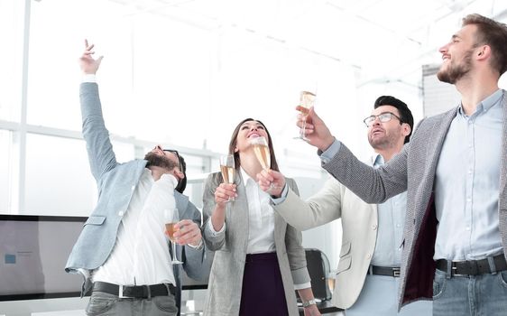 group of happy employees celebrate their success in the workplace.photo with copy space