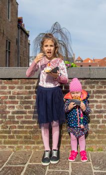 Belgian waffles are eaten by children on the street. Selective focus. Food.