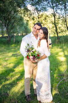 nice portrait of beautiful and young groom and bride outdoors