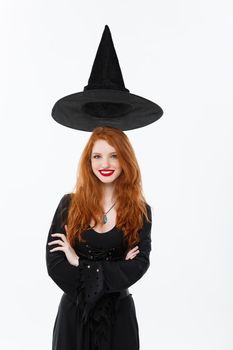 Halloween witch concept - Happy Halloween Sexy ginger hair Witch with magic hat flying over her head. Isolated on white background