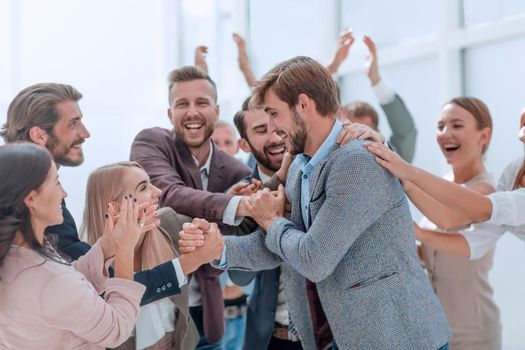 corporate group of employees applauding their colleague. photo with copy space