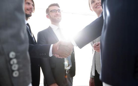 Successful business people handshaking after good deal.