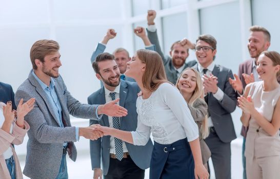 happy employees congratulating their leader. success concept