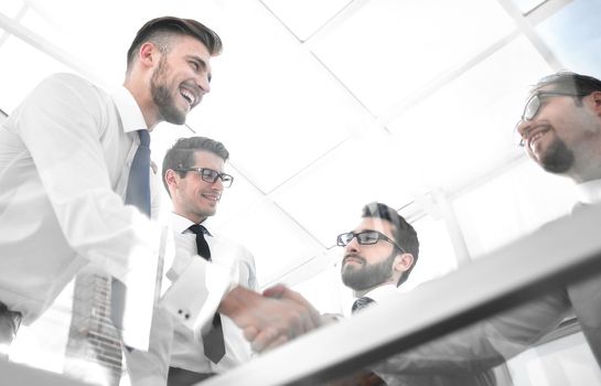 bottom view. handshake employees over the Desk.the concept of teamwork