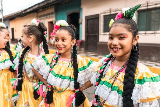 Group of girls in folkloric costume on a street in Leon Nicaragua